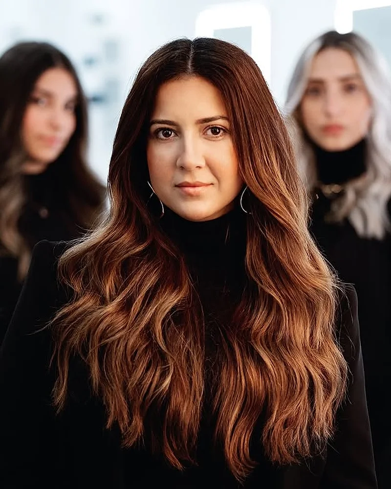 Amanda Dantas, especialista em madeixas, com a equipa do salão ao fundo